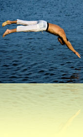 Swimmer jumping into water